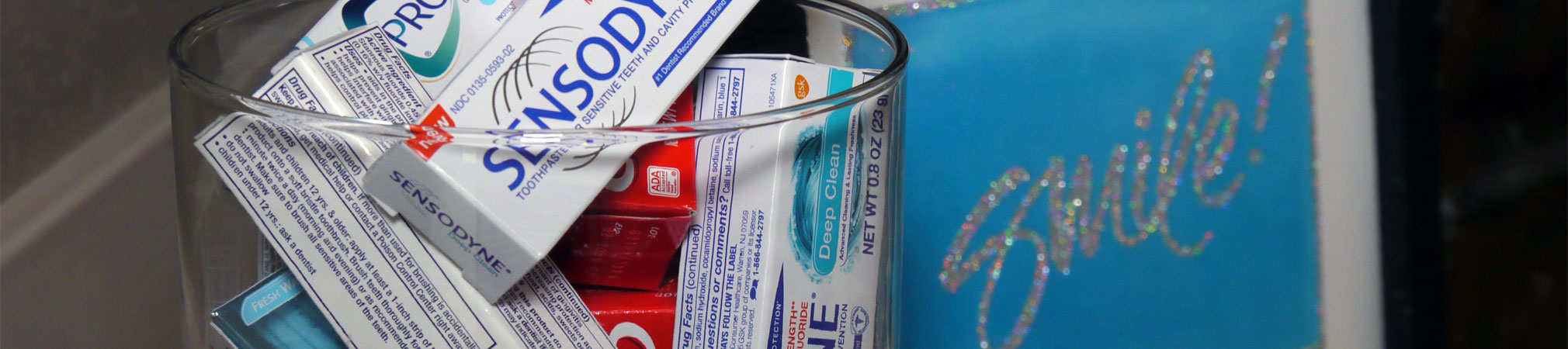A collection of different brands of toothpastes